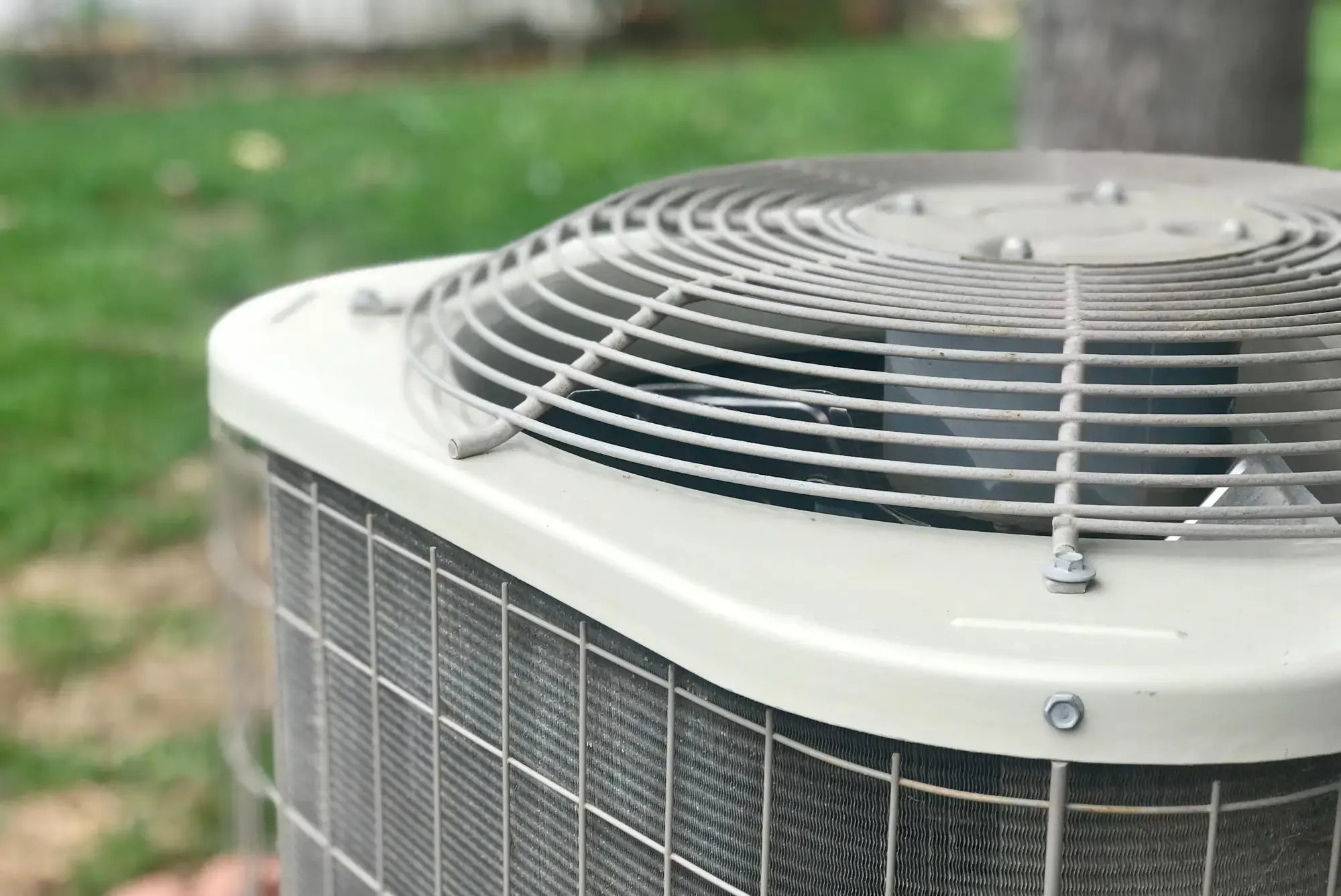 New residential AC condenser installed outside a home