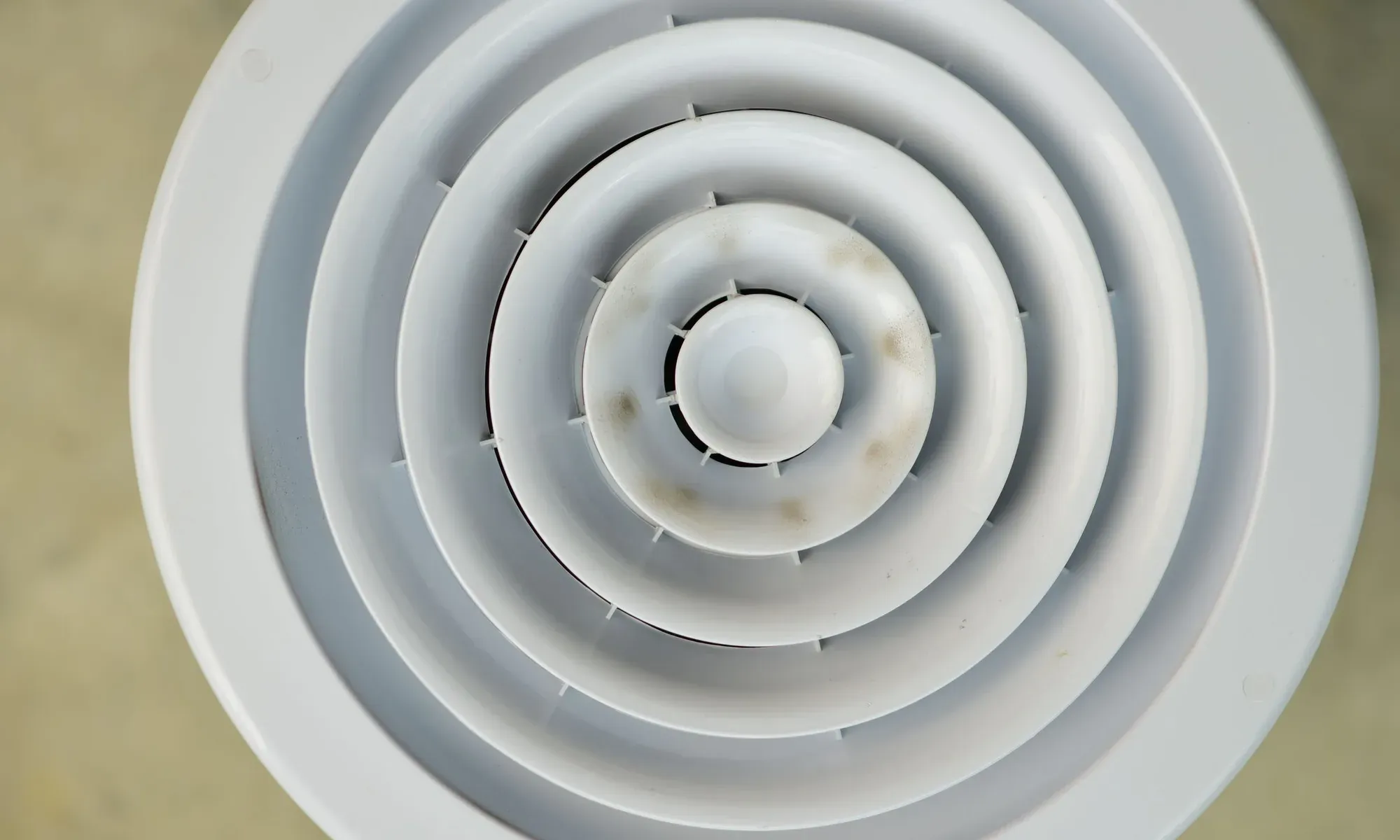A floor supply vent in a Northwest Indiana home where duct leaks cause uneven comfort.