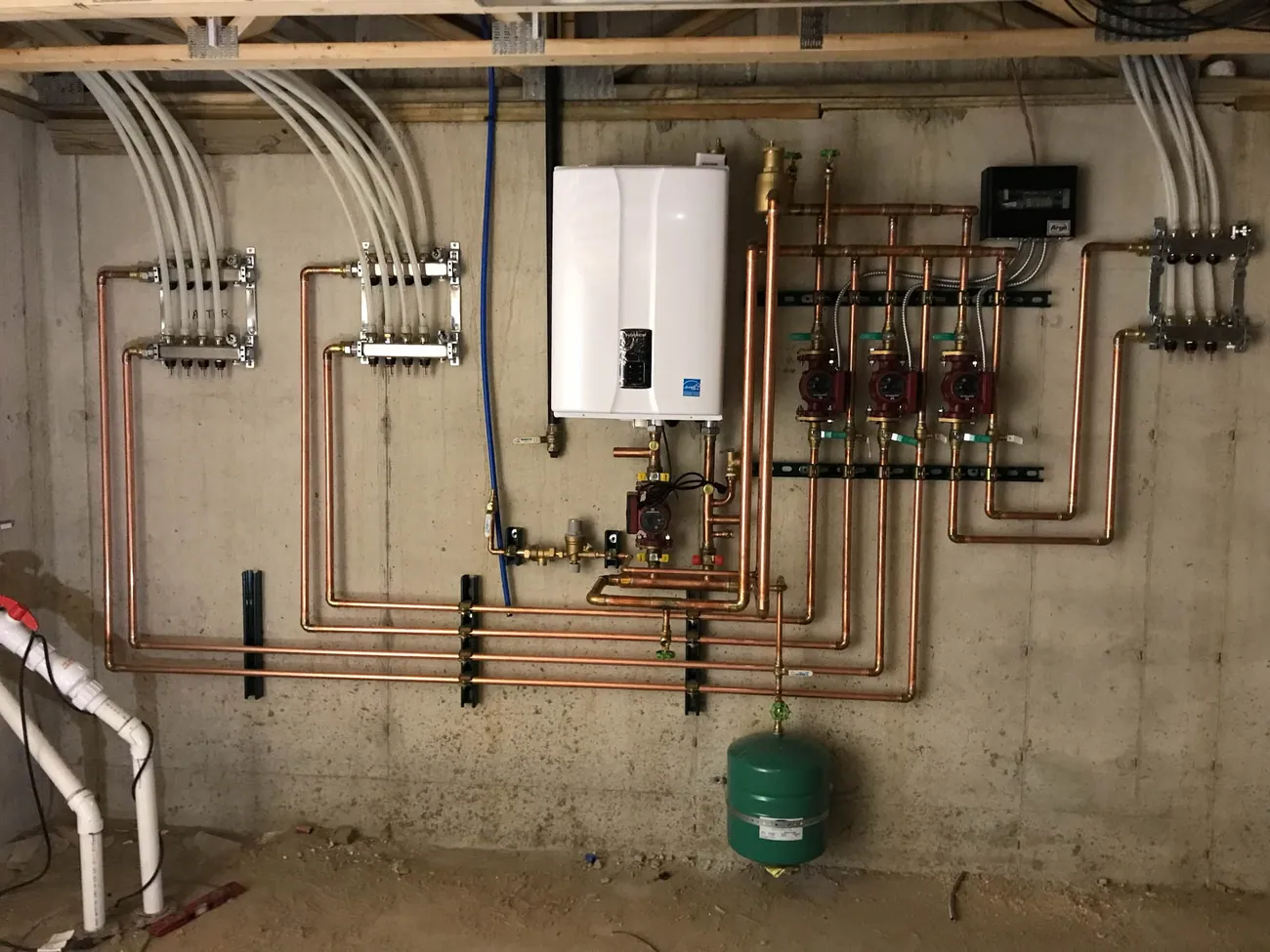Wall-hung condensing boiler with copper piping and circulator pumps installed in a Northwest Indiana home