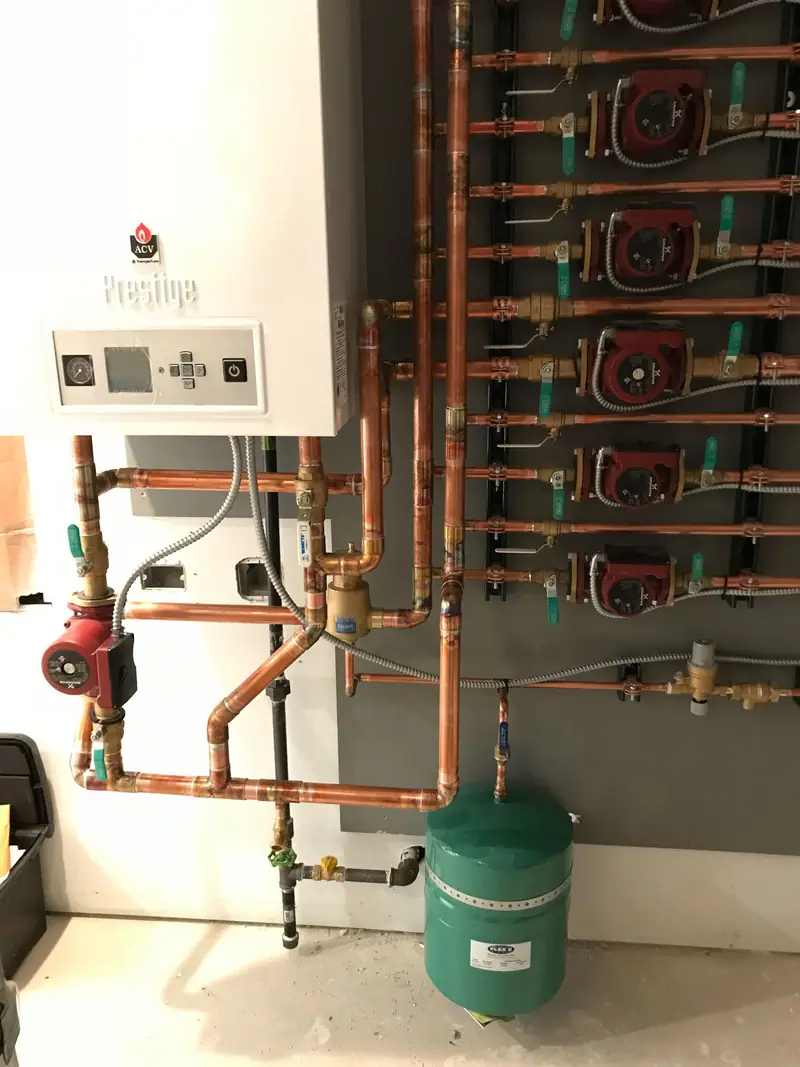 ACV Prestige condensing boiler with copper piping, a red circulator pump, and a green expansion tank.