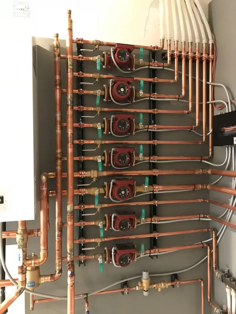 ACV Prestige boiler piped to seven zone circulator pumps and a green expansion tank.
