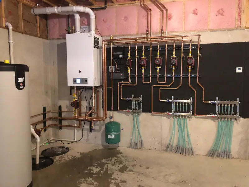 Wall-hung boiler, indirect Smart storage tank, and copper piping feeding radiant floor manifolds.