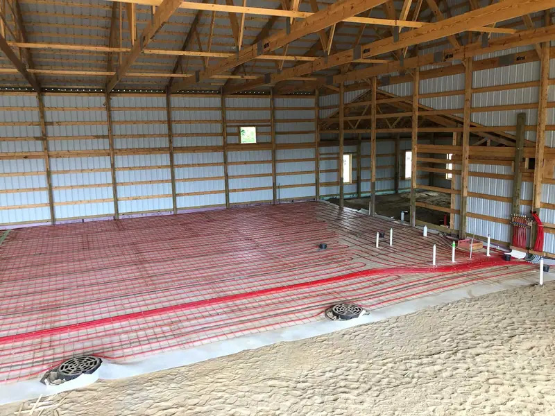 Panoramic view of radiant PEX tubing covering an entire pole-barn floor before concrete.