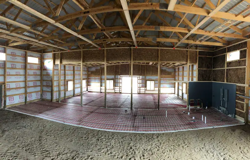 Wide interior view of radiant tubing laid across a framed home before the slab pour.